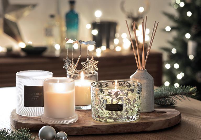 Image of a selection of candles a.nd diffusers on a table.
