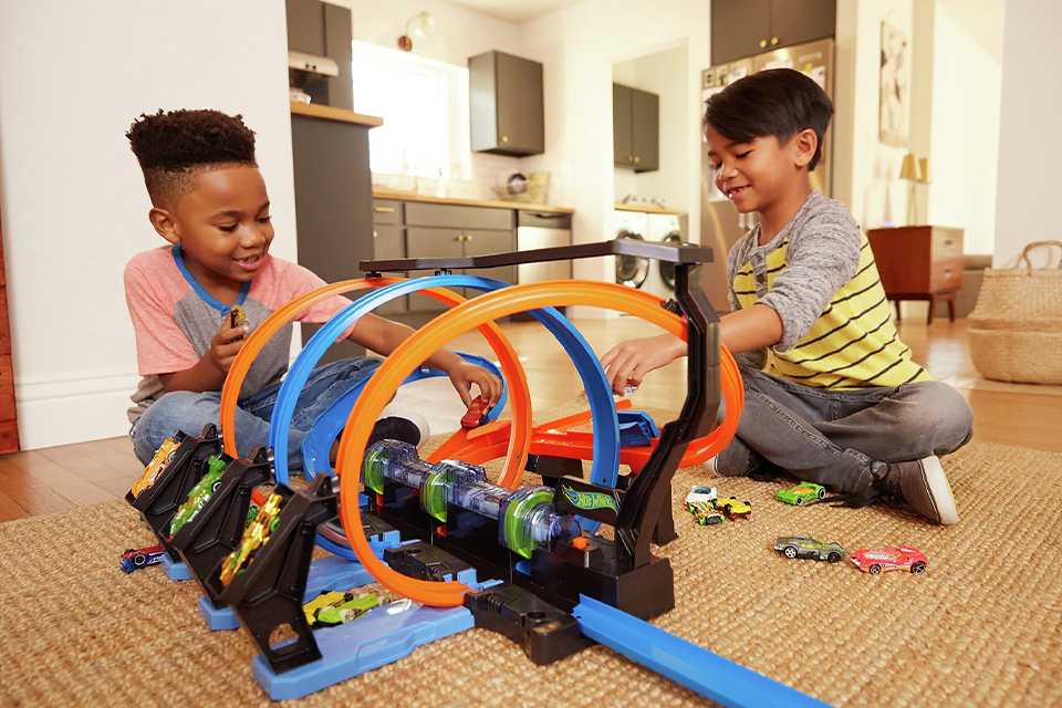 Friends playing with Hot Wheels Corkscrew Crash Track Set.