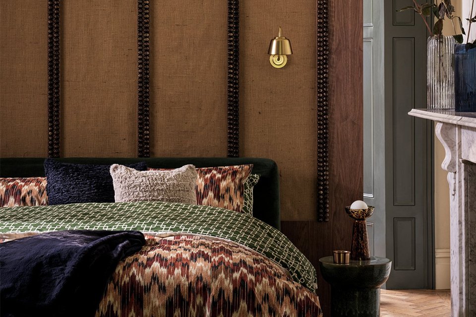 Habitat Ribbed Glass Vase in blue colour placed in a bedroom.