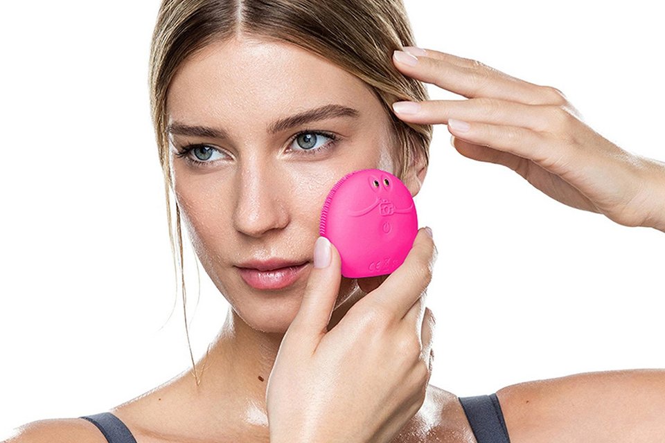 woman using facial tool 