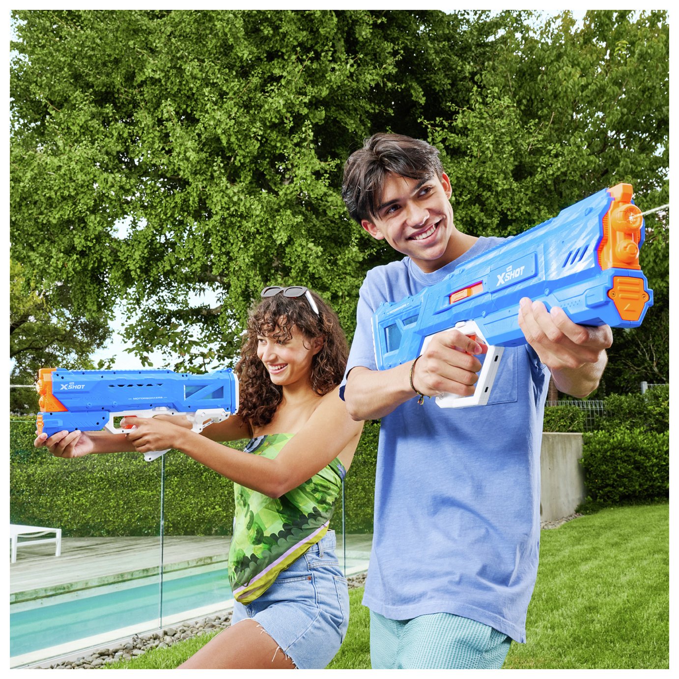 Two kids playing with an XSHOT Water Hydra Pulse Motor Soaker.