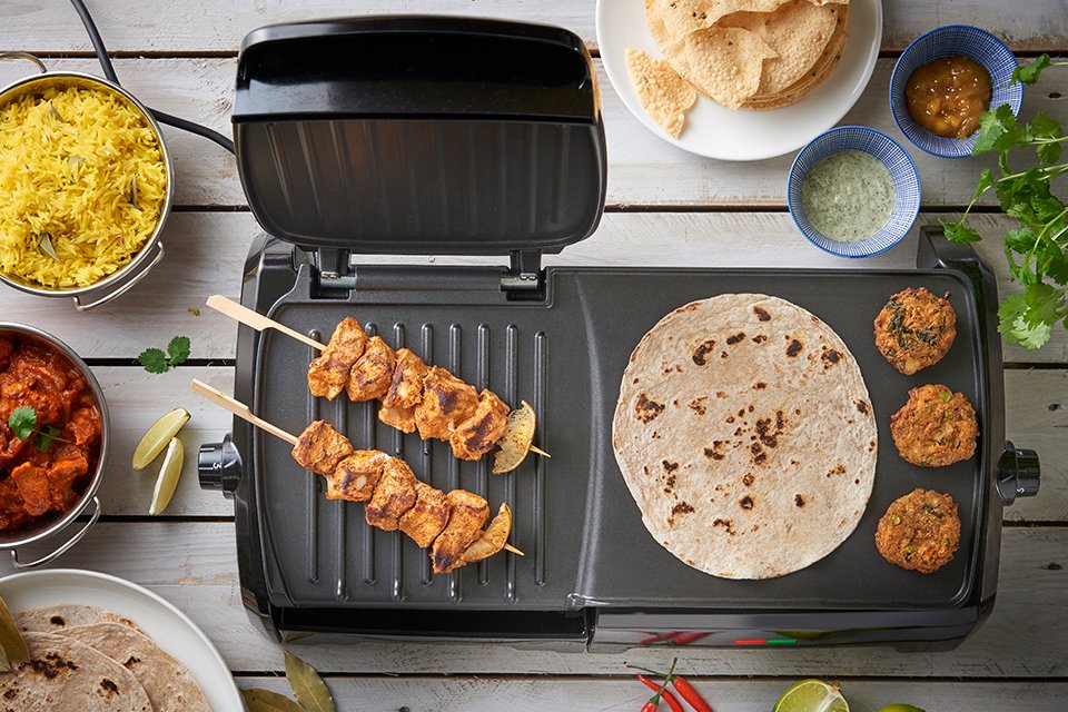 A George Foreman grill with delicious food being grilled on it.