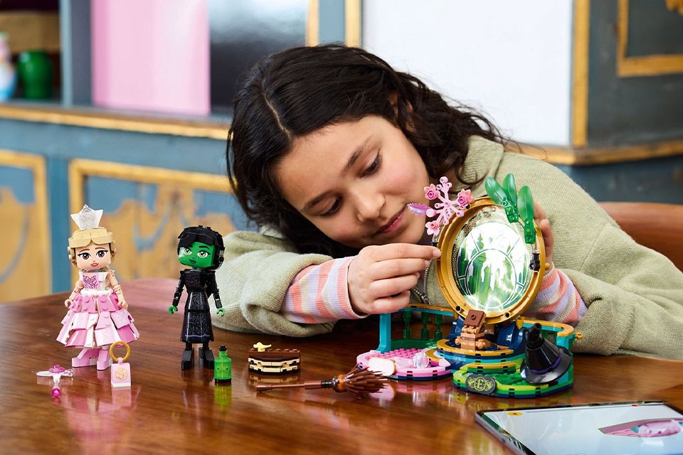 A girl playing with LEGO® Wicked Elphaba & Glinda Figures Building Toy Set.