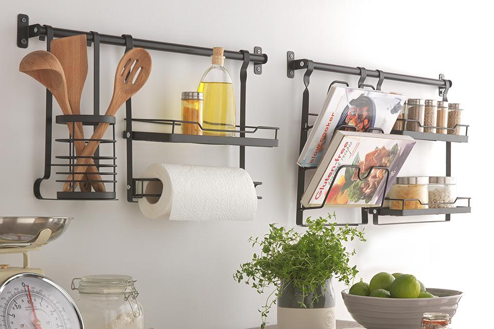 A Habitat wall mounted storage system with cookbooks and other kitchen essentials.