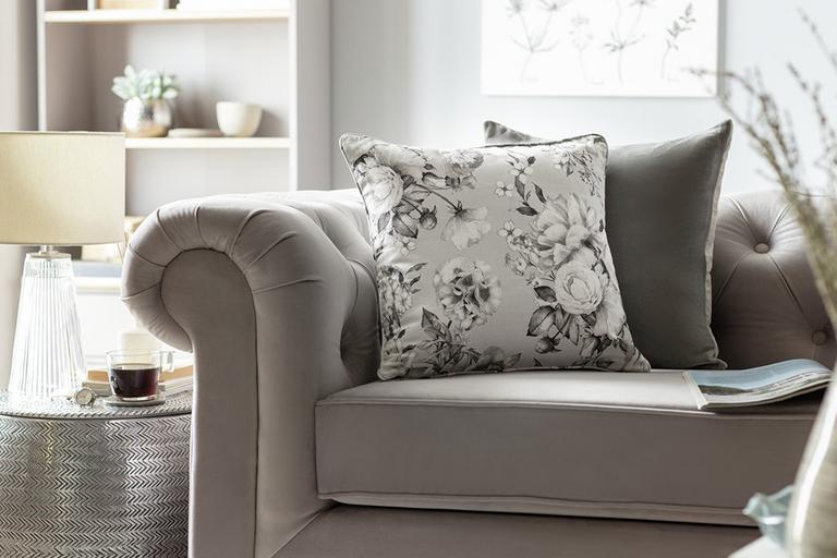 Cushions on grey sofa in living room.
