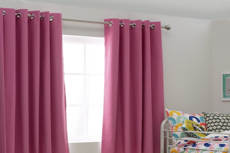 Argos Home Kids Blackout Eyelet Curtains in pink colour put in a kid's bedroom.