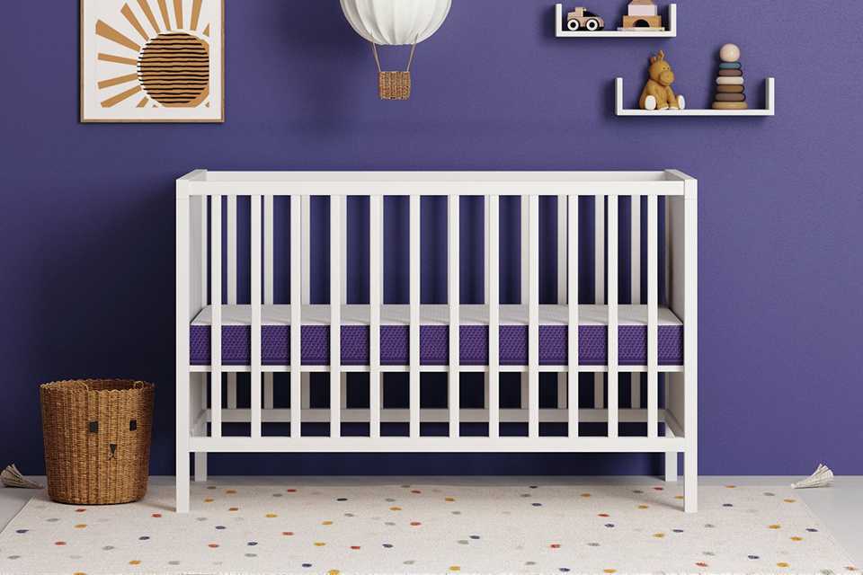 Snuz Surface Duo Cot Bed Mattress on a white cot.