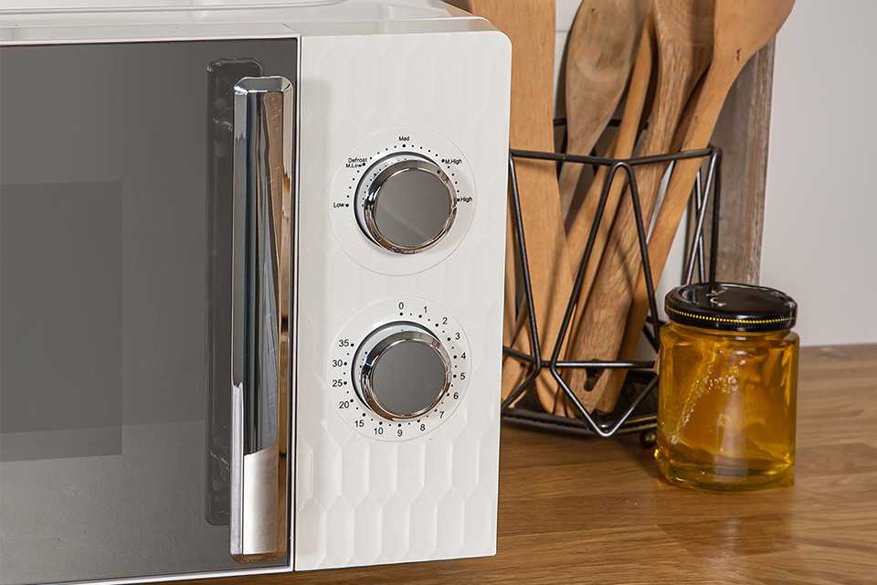 A white Russell Hobbs microwave with chrome handle and dials.