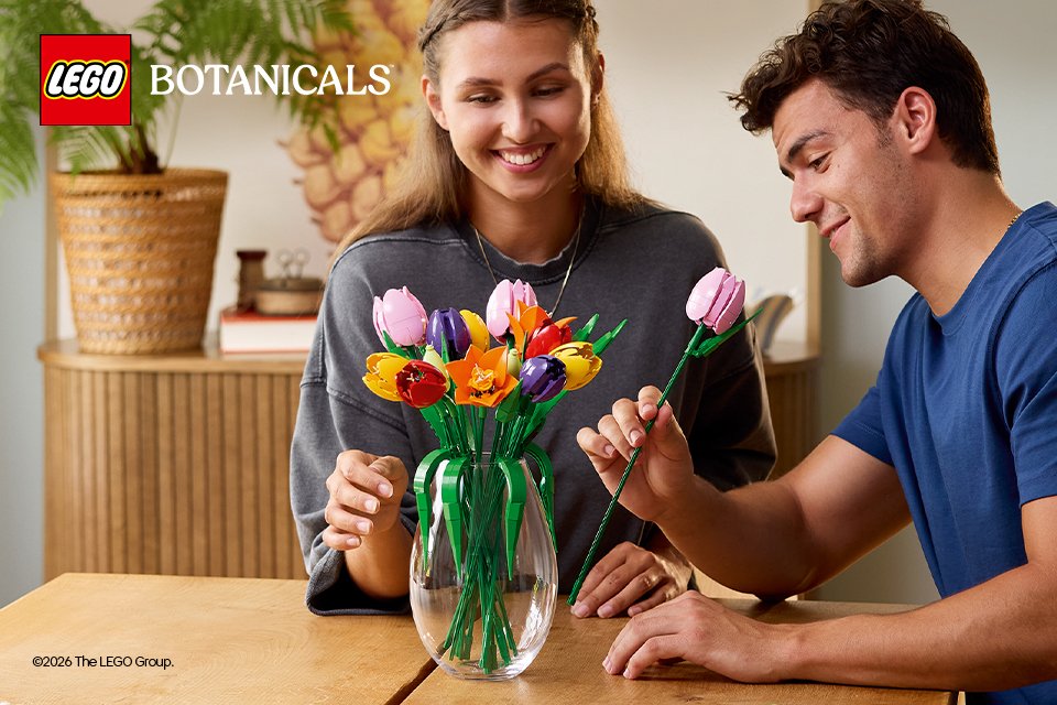 A man and woman admiring the LEGO® Tulips 11501 set.