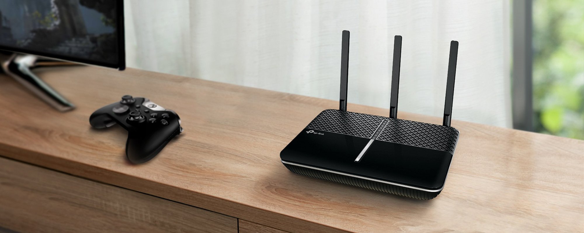  A black TP link wireless WiFi router placed on a wooden TV unit. 