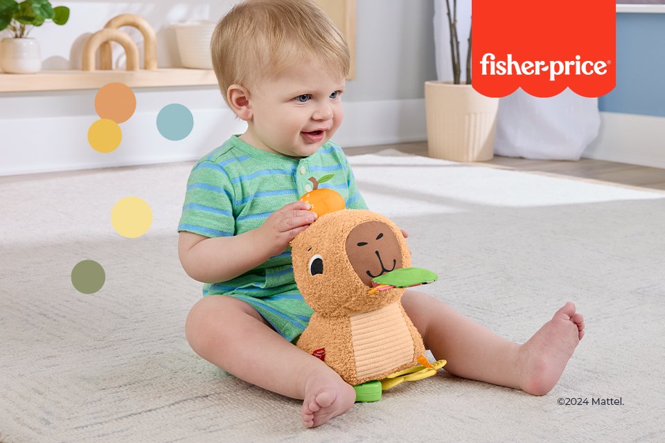 Baby playing with Fisher-Price sensory toy.
