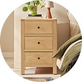 A Habitat wooden bedside table in a bedroom.
