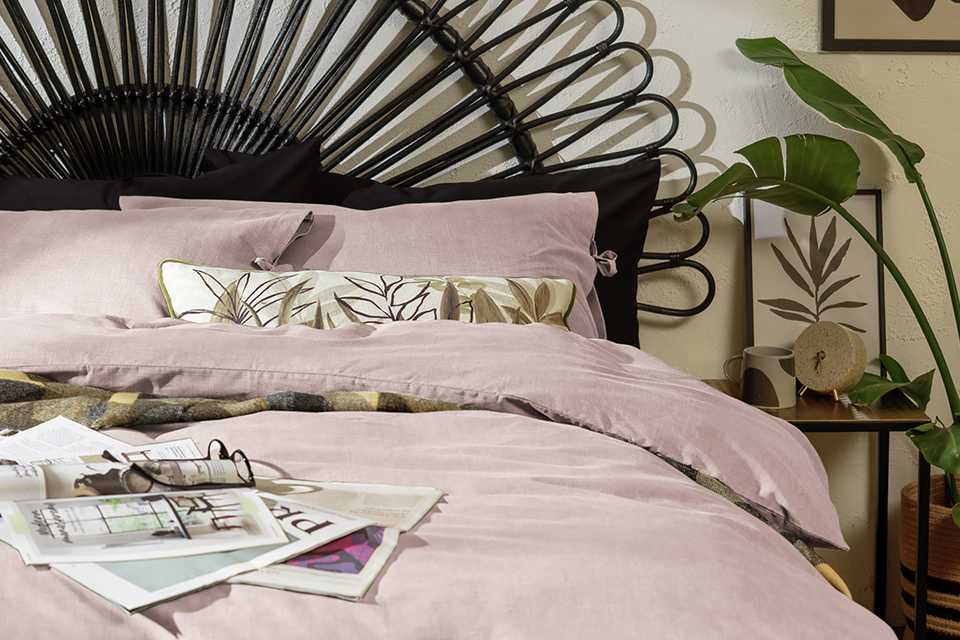 Light pink coloured bedding on a mattress.