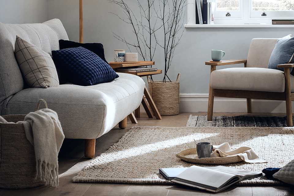 A sofa, a chair and a floor lamp in a small living room.