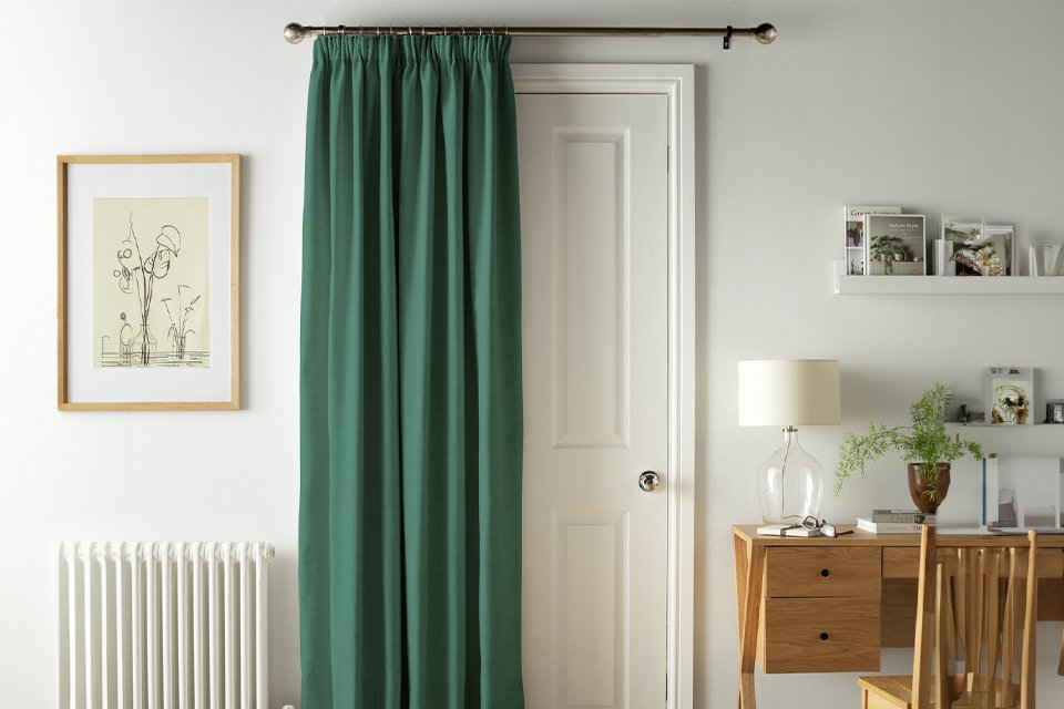 Argos Home thermal green door curtain behind a door.