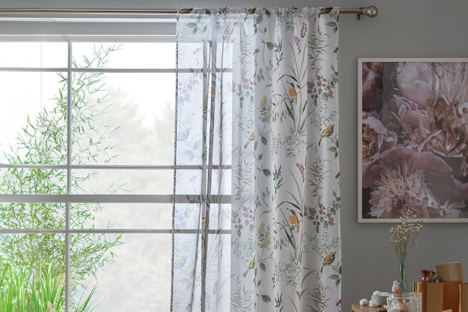 A pair of Habitat birds voile curtain panel.