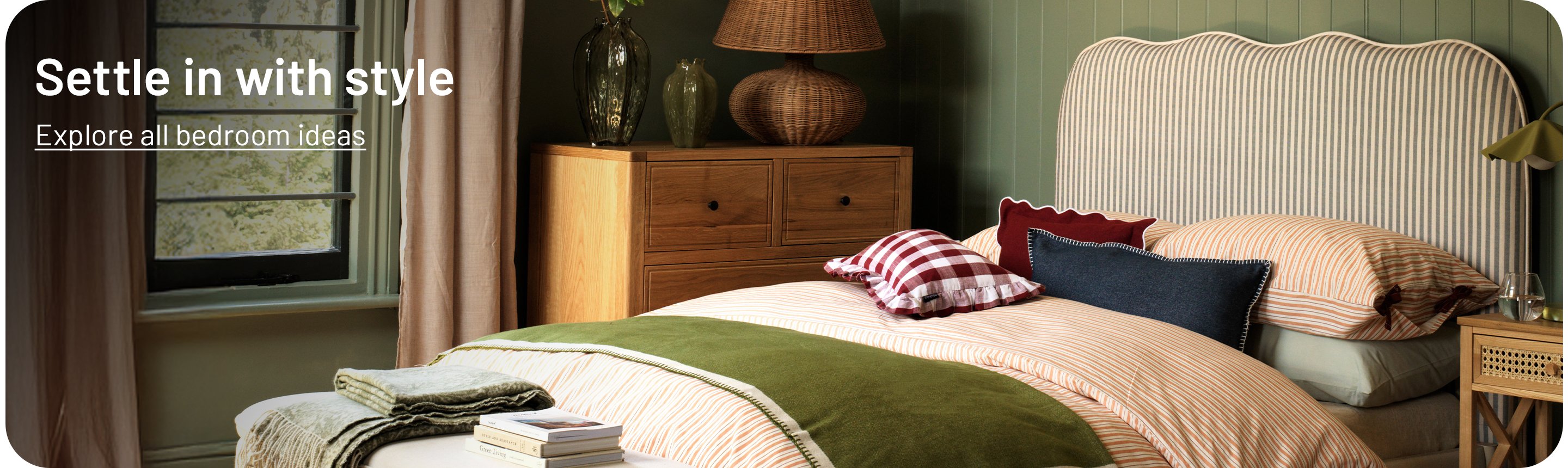 A banner with a bed with cosy bedding next to a bedside table and a window.
