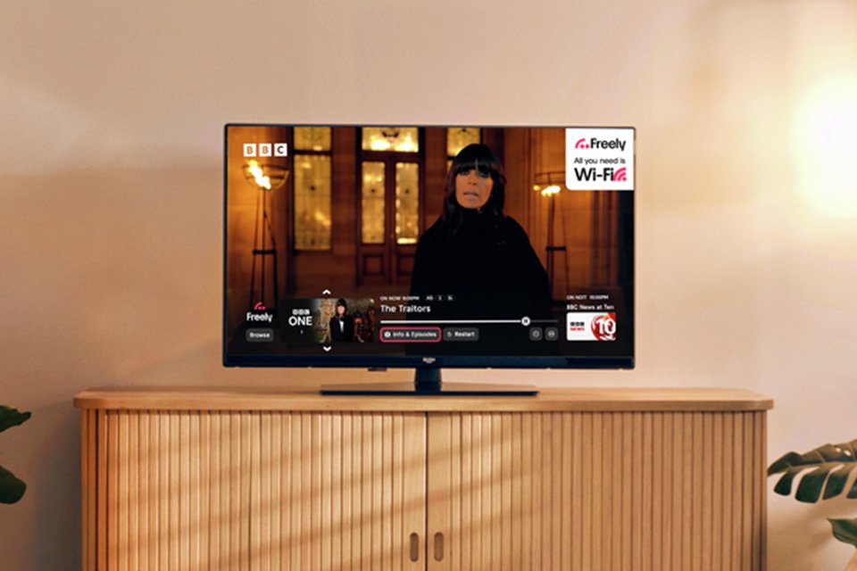 A Bush 32Inch 32FT25CB Smart FHD HDR LED Freely TV above a TV unit.