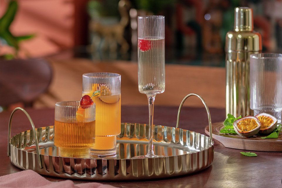 Habitat Gold Tone Tray carrying cocktails and mocktails.