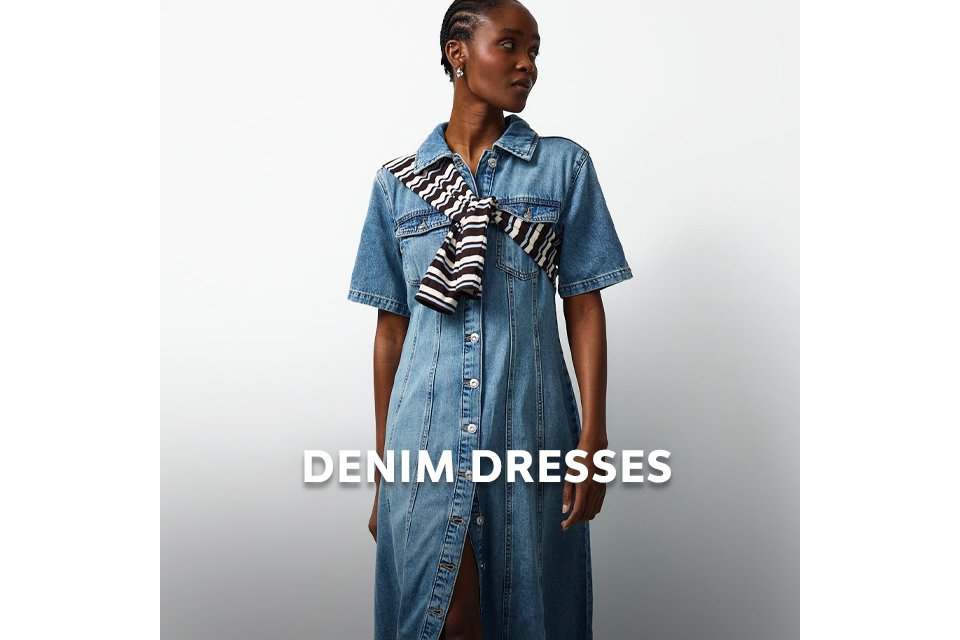 Person wearing a blue denim dress styled with a striped scarf for an elevated casual look.