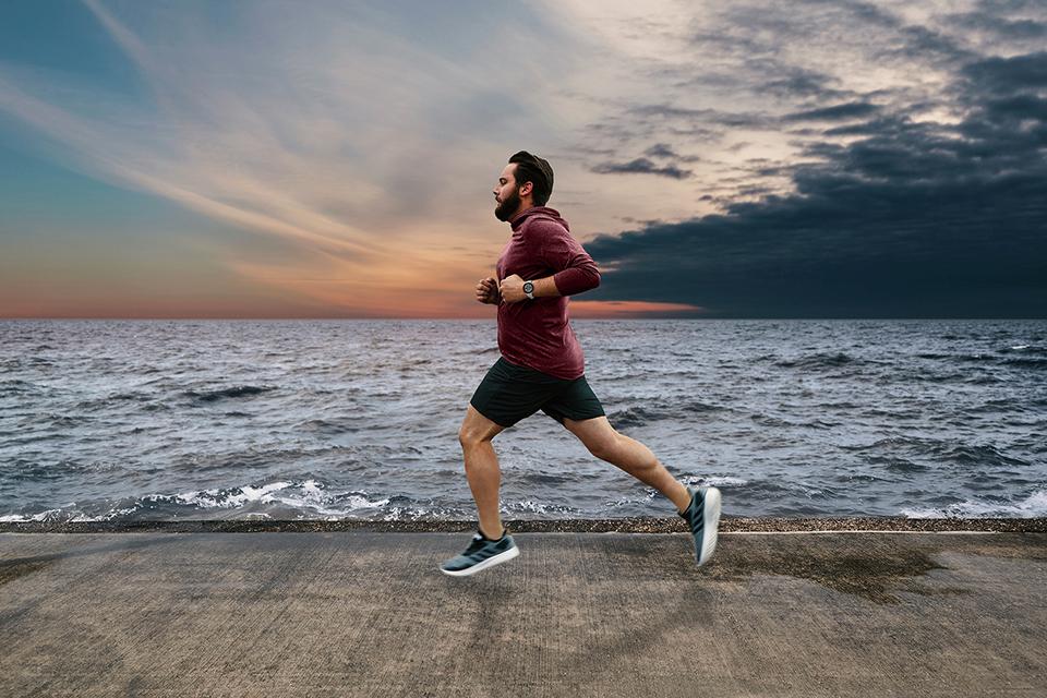 Man running alongside the ocean.