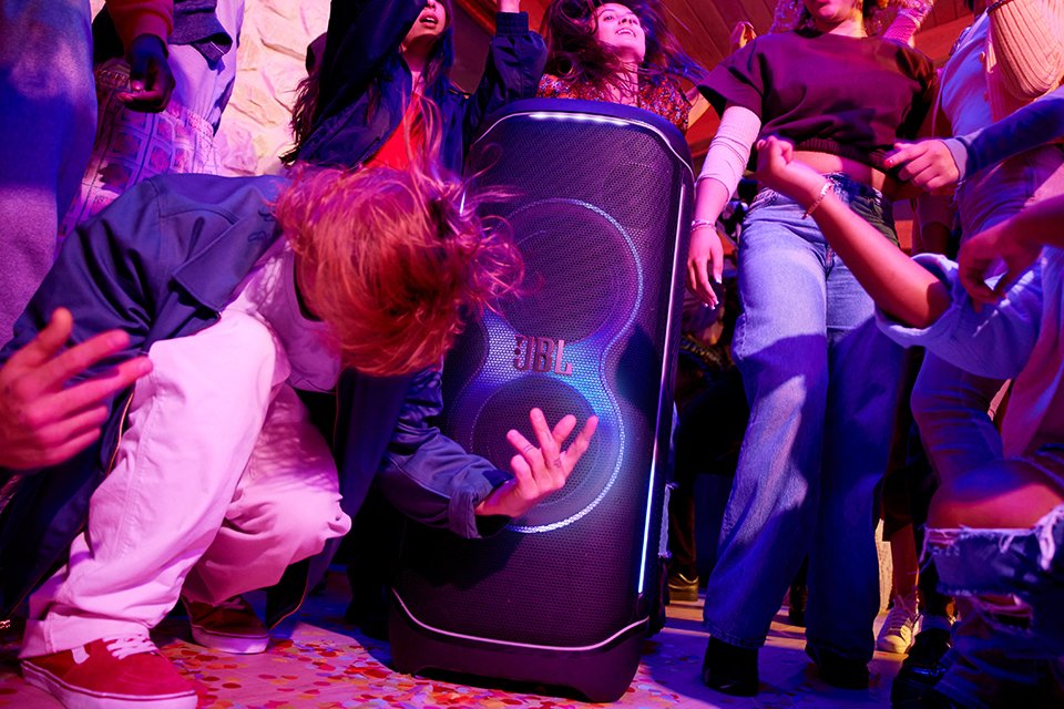 People dancing at a party with JBL Partybox ultimate speaker.