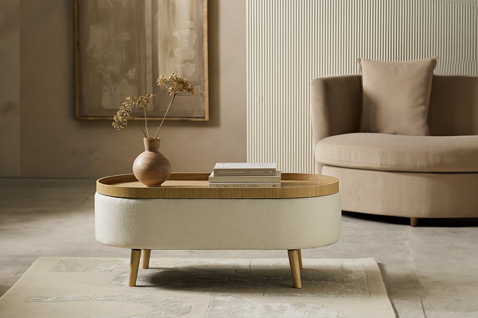 Habitat Ingo coffee table in cream colour placed in front of an armchair. 