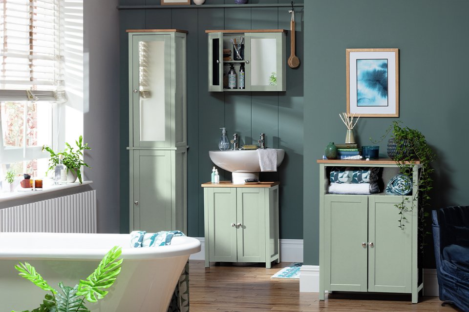 Argos Home Livingston bathroom furniture set including a tall boy, under sink storage, a mirrored cabinet and more in sage green colour.