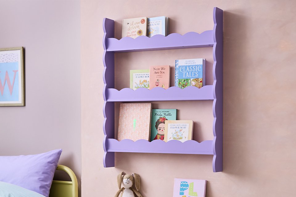 Habitat Flo wavy wall storage in lilac colour with books stored in it. 