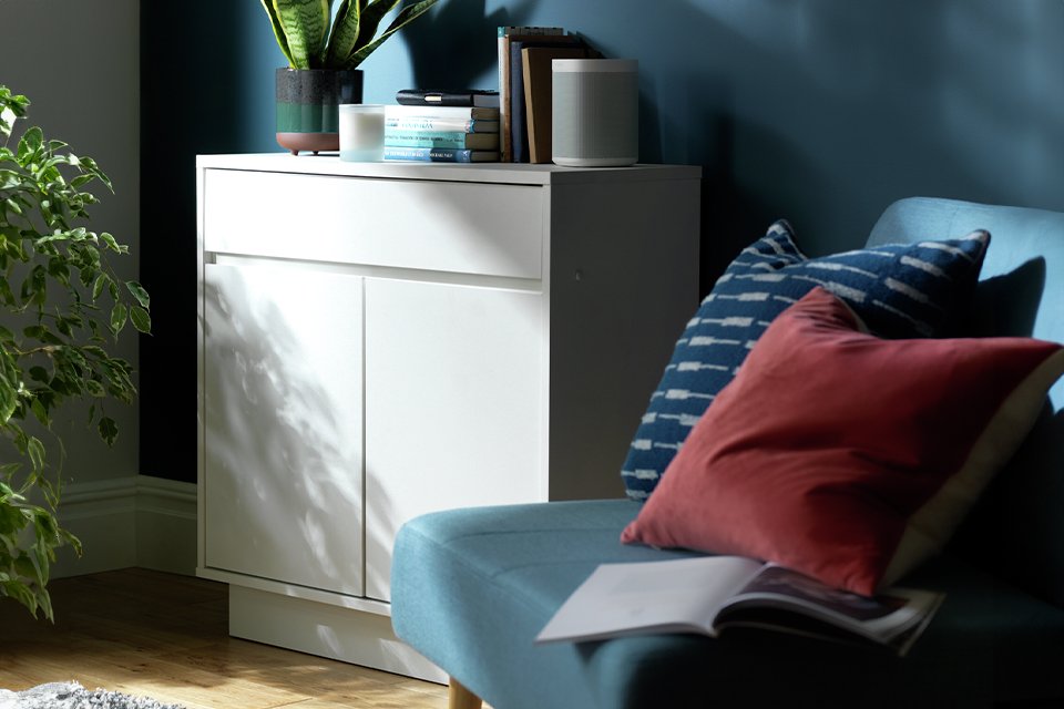 Argos Home Cubes SML sideboard in white colour placed next to a blue armchair.