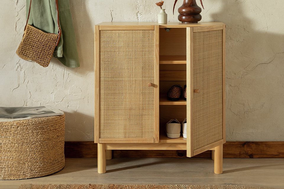 A Habitat Simone shoe cabinet placed in a hallway with a wooden vase on top of it. 