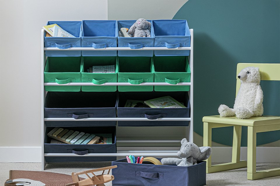 Toys in a four tier children's basket and storage unit in green and blue.
