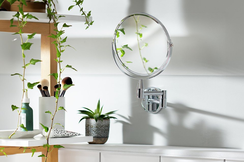 An Argos Home chrome extending round shaving mirror in a bathroom.