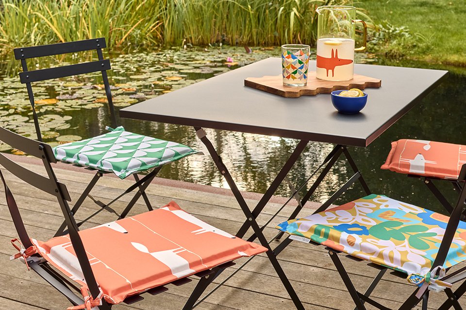 Cutting a box hedge with hand shears.