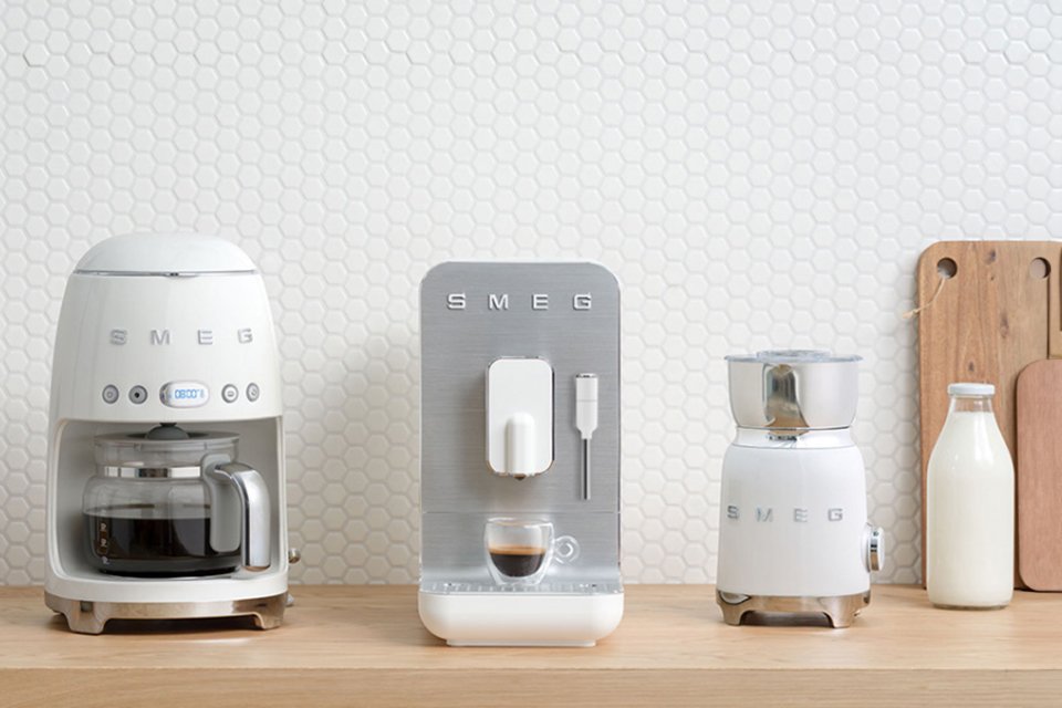 White Smeg drip coffee machine, bean to cup and milk frother.