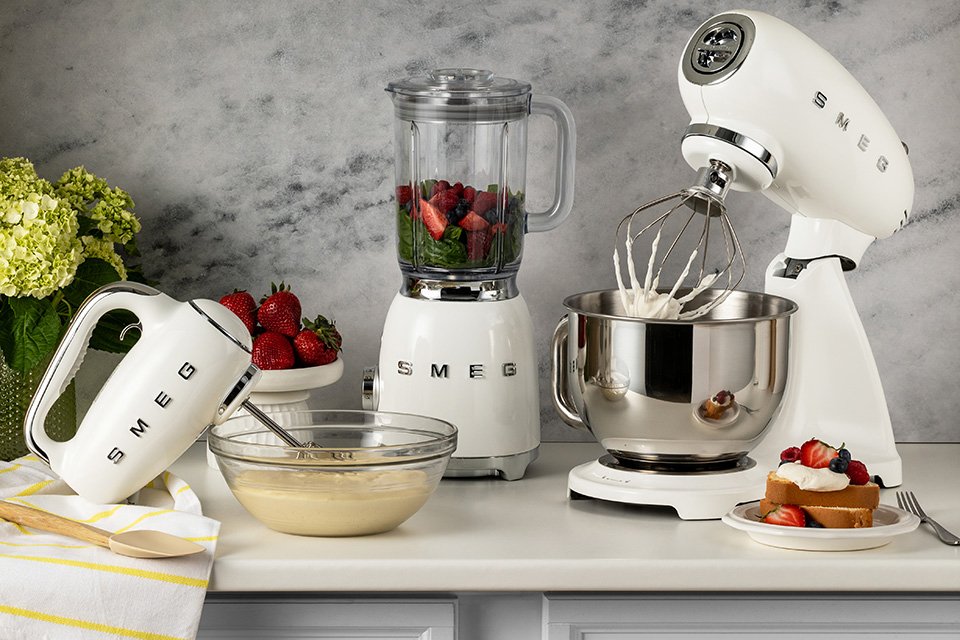 White Smeg hand mixer, blender and stand mixer.
