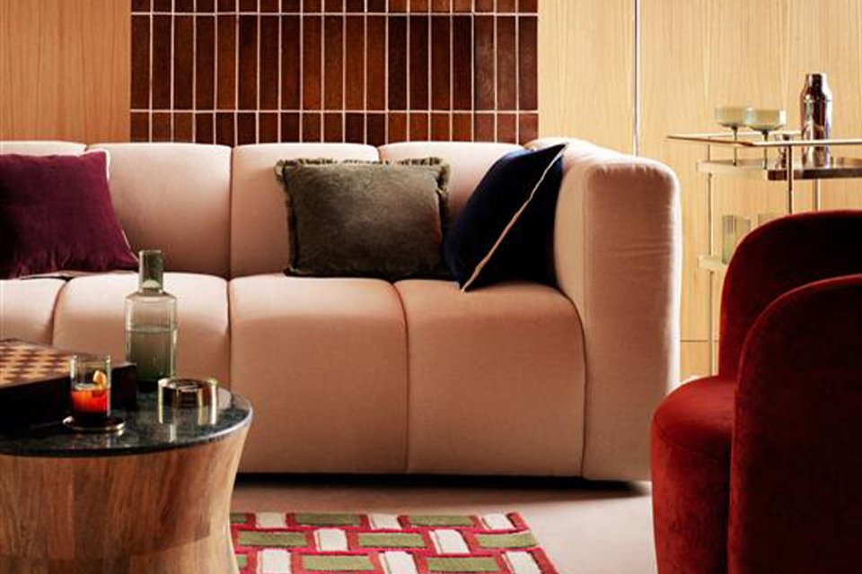 A chunky, soft sofa with soft cushions on it in a living room.