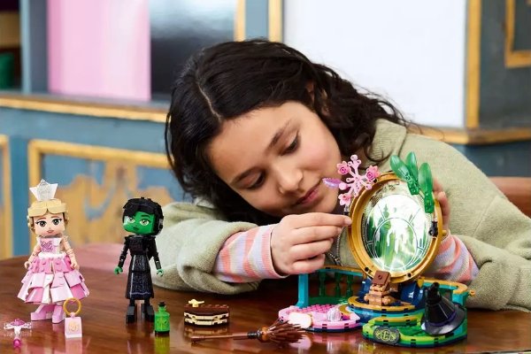 A girl playing with toys at a table.