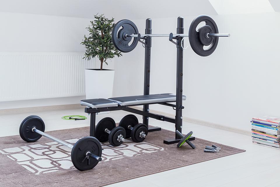 A weight bench in a small home gym.