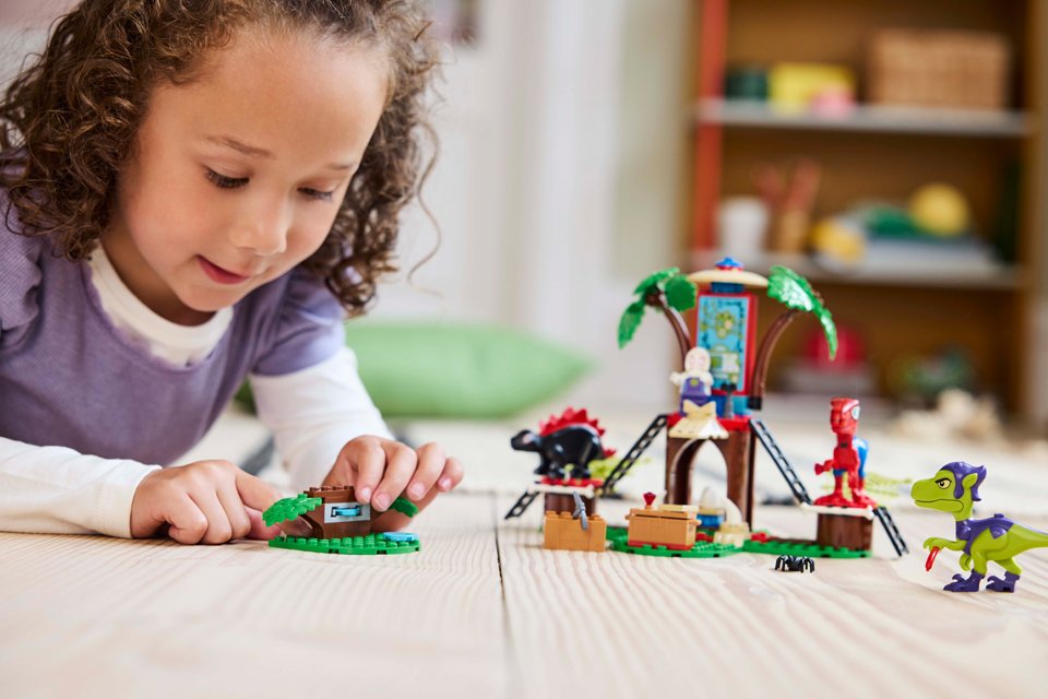 Girl playing with LEGO® Marvel Spidey and Friends Gobby’s Raptor Battle at Tree House set.