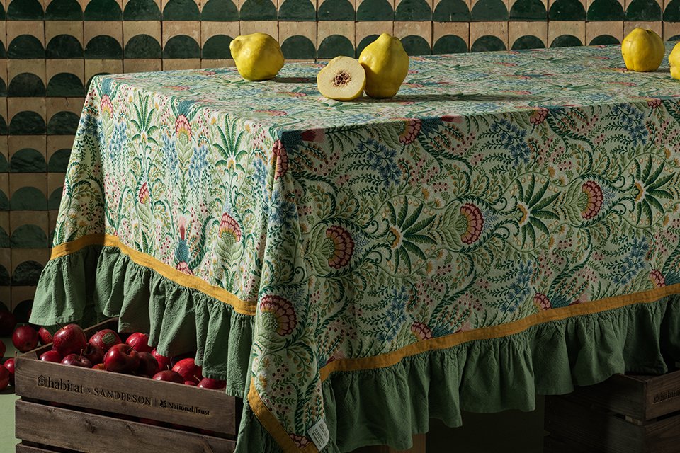 Habitat x National Trust floral printed cooking mitten on top of cherries.