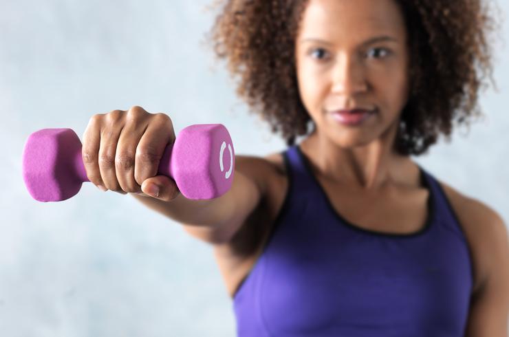 A woman exercising with a dumbbell.