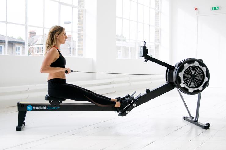A woman working out on a rowing machine.