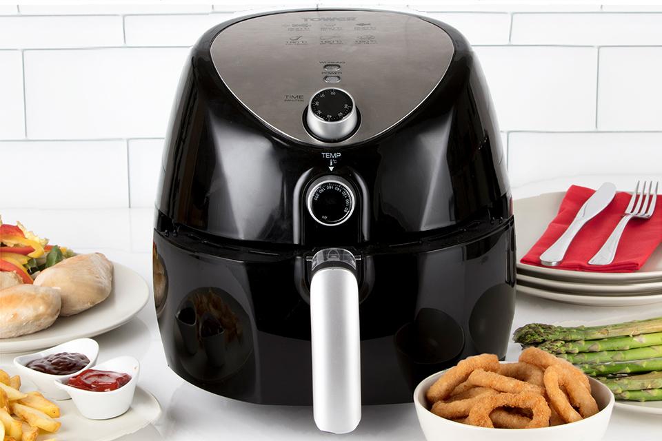 Air fryer surrounded by ingredients.