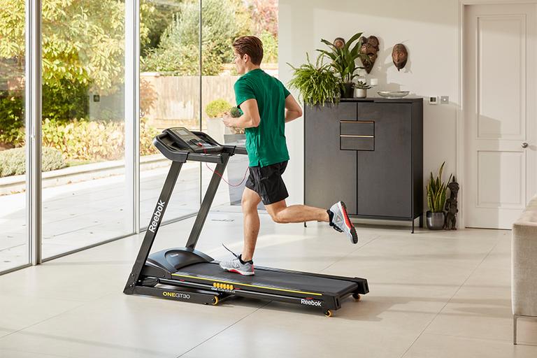 A man running inside on a treadmill.