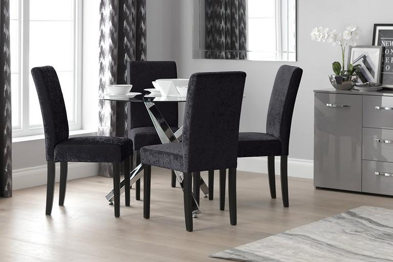 Argos Home Ava Glass 4 Seater Round Dining Table with 4 black chairs surrounding it.