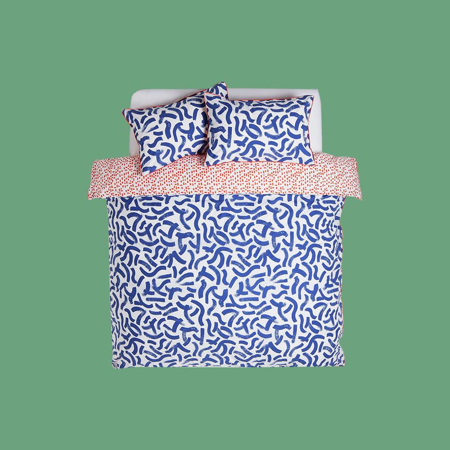 Double sided blue and white and light orange pattrened bedding.