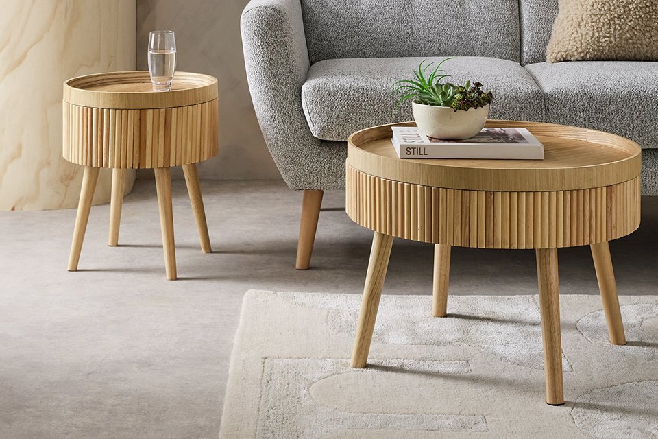 Habitat Agnes side table in oak finish placed next to a grey sofa and Agnes coffee table.