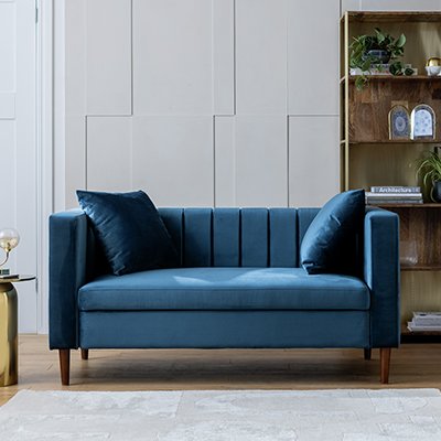 An Argos Home Everly blue velvet 2 seater sofa in a living room.