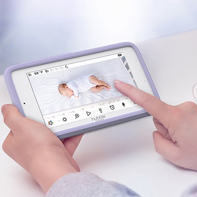 A parent watching their child over a baby monitor.